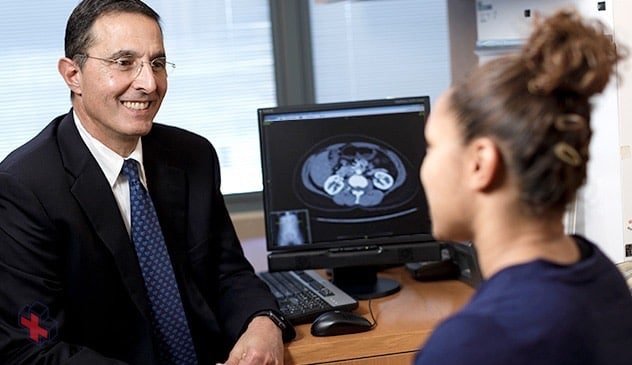 A urologic surgeon discusses the best surgical approach with a kidney tumor patient.